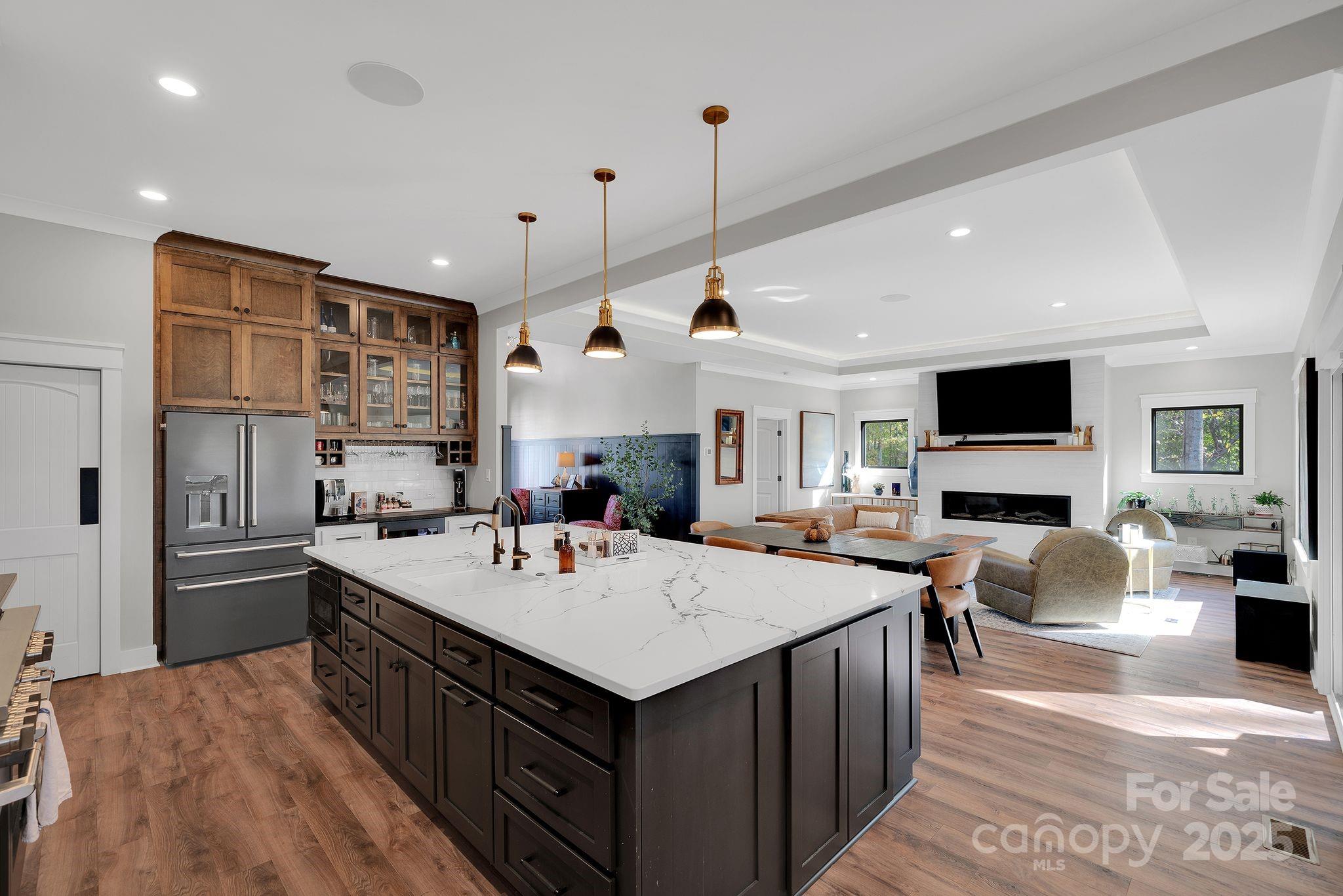 4111 Ridge Drive Northeast Conover, NC 28613 - Photo 13 of 39 a kitchen with a stove a refrigerator a sink dishwasher with a dining table and chairs with wooden floor