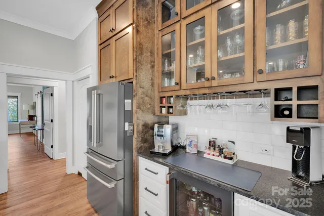 a kitchen with stainless steel appliances granite countertop a refrigerator and a stove