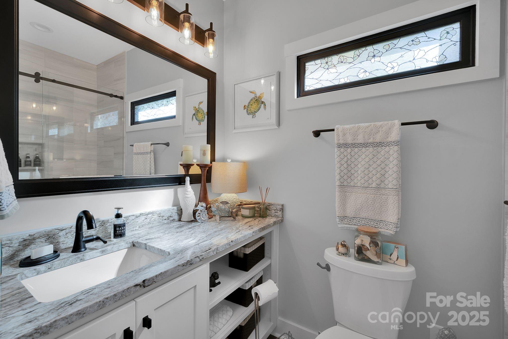 4111 Ridge Drive Northeast Conover, NC 28613 - Photo 18 of 39 a bathroom with a granite countertop sink mirror vanity and toilet