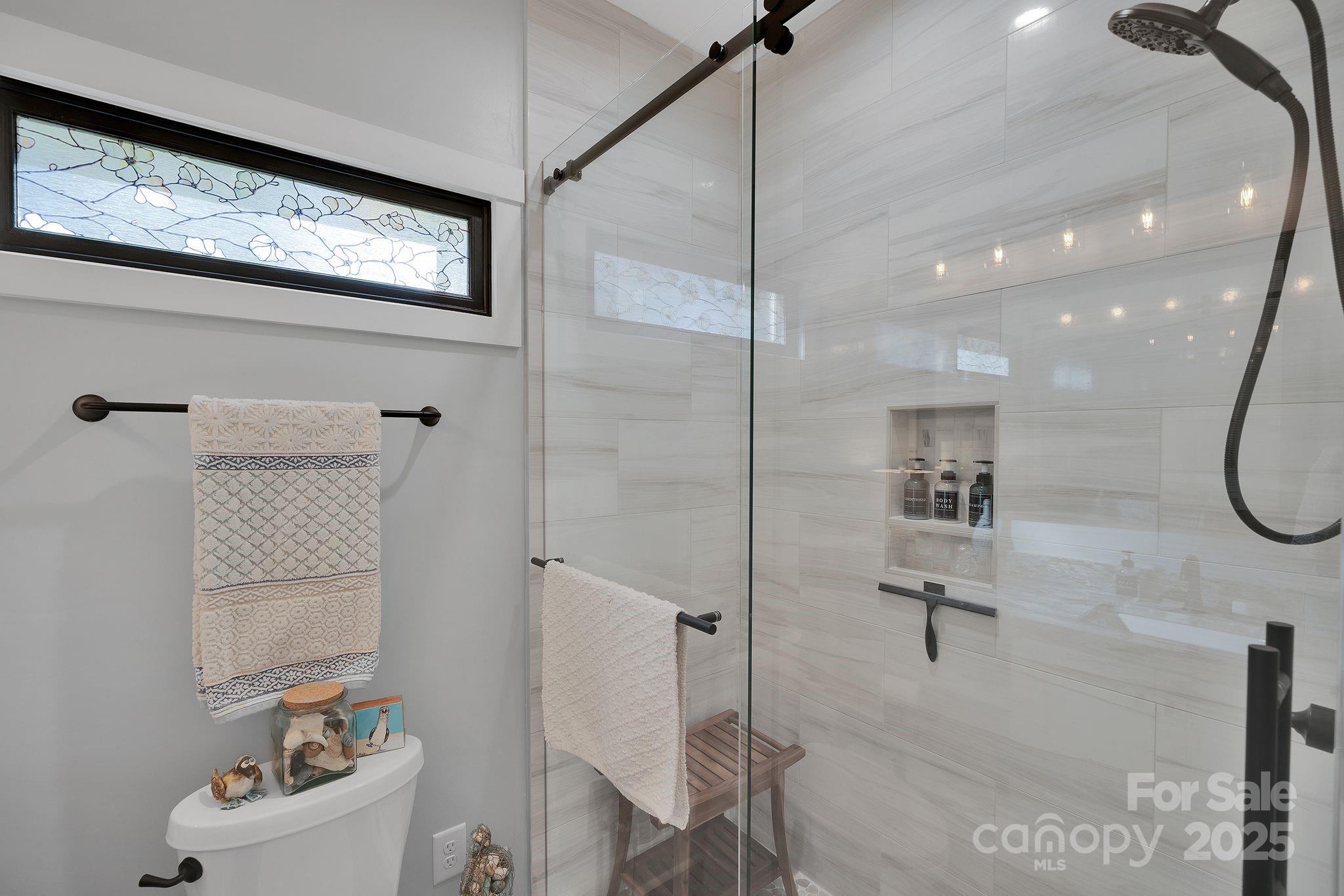 4111 Ridge Drive Northeast Conover, NC 28613 - Photo 19 of 39 a bathroom with a bathtub a toilet and a shower