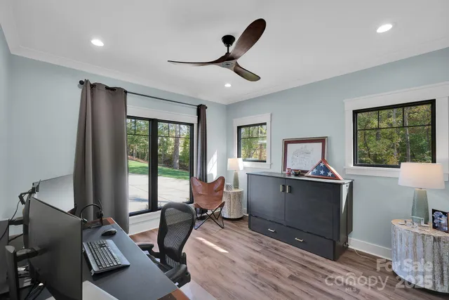 a living room with furniture a window and a flat screen tv