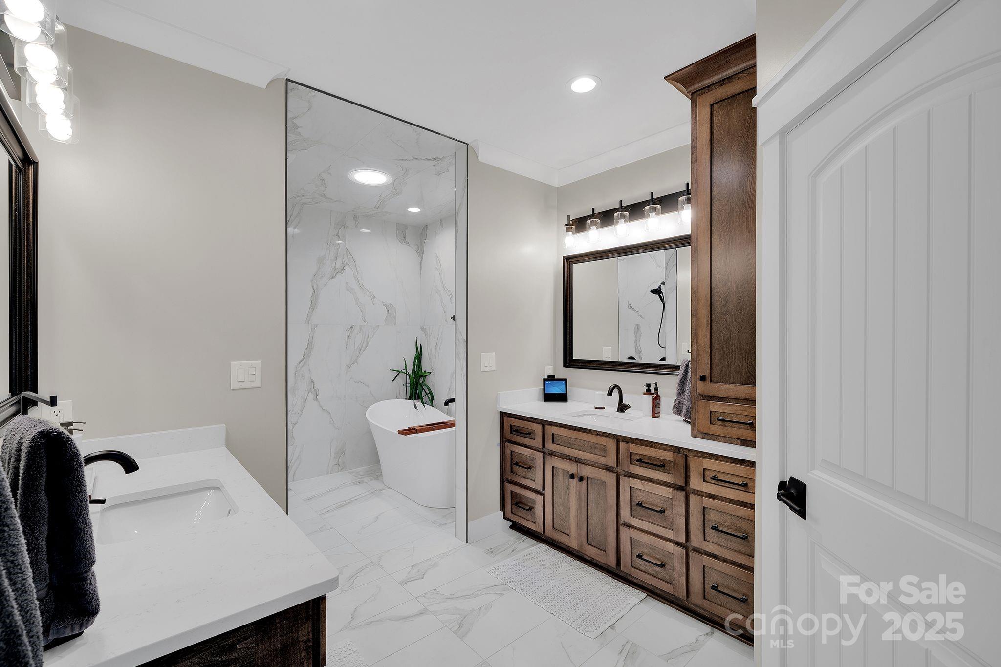 4111 Ridge Drive Northeast Conover, NC 28613 - Photo 23 of 39 a bathroom with a double vanity sink a toilet a mirror and shower