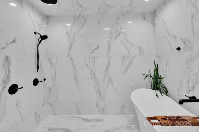 a bathroom with a tub sink and mirror