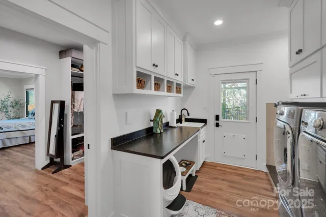 a kitchen with a sink appliances and cabinets