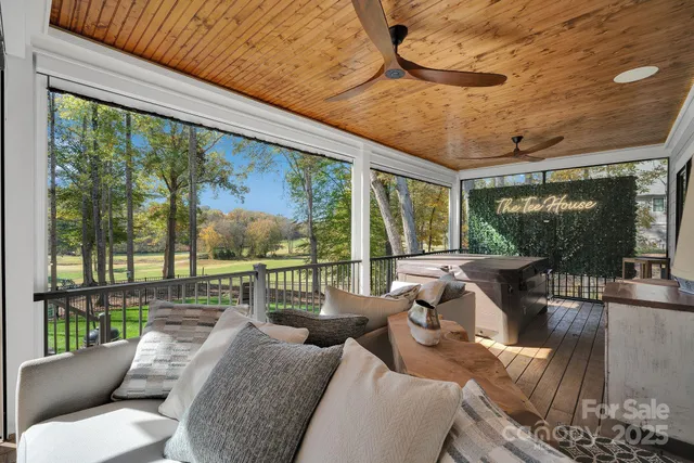 a balcony with furniture and a floor to ceiling window