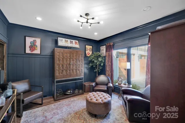 a living room with furniture a chandelier and a window