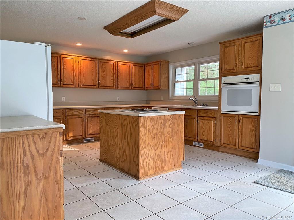 2641 Cameron Road Chester, SC 29706 - Photo 11 of 46 a kitchen with stainless steel appliances granite countertop a stove a sink and a microwave