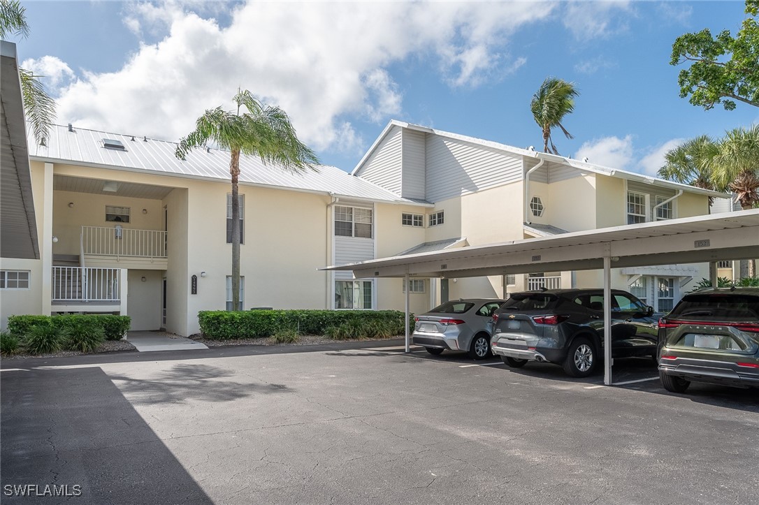14995 Rivers Edge Court, Unit 151 Fort Myers, FL 33908 - Photo 1 of 18 a car parked in front of white building