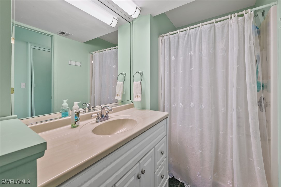 14995 Rivers Edge Court, Unit 151 Fort Myers, FL 33908 - Photo 13 of 18 a bathroom with a sink and a mirror