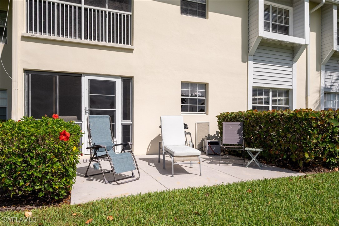 14995 Rivers Edge Court, Unit 151 Fort Myers, FL 33908 - Photo 14 of 18 a view of a house with backyard and sitting area