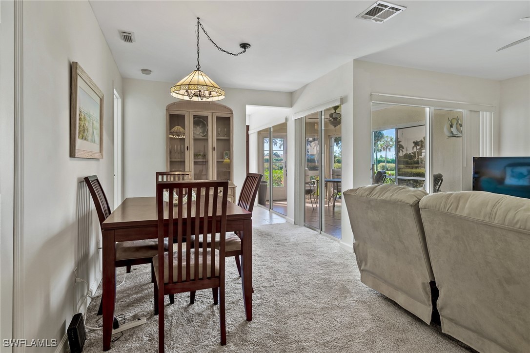 14995 Rivers Edge Court, Unit 151 Fort Myers, FL 33908 - Photo 18 of 18 a view of a dining room with furniture window and wooden floor