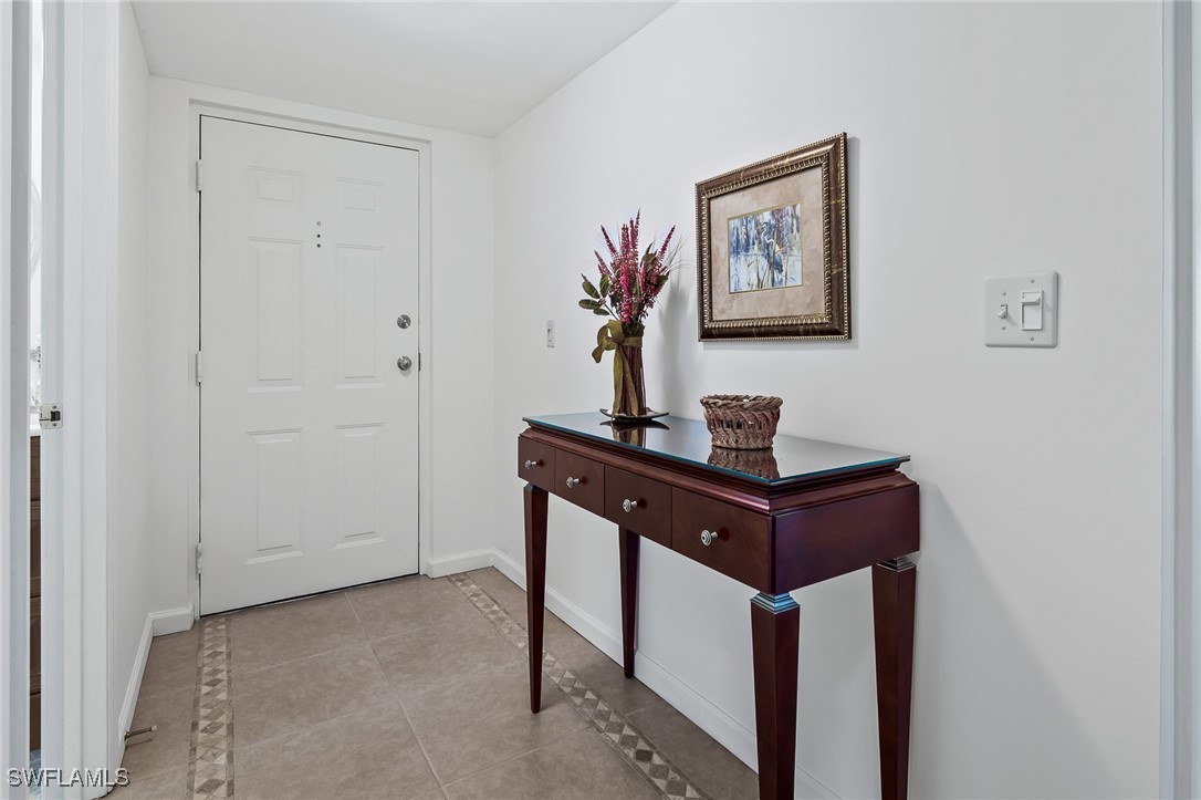 14995 Rivers Edge Court, Unit 151 Fort Myers, FL 33908 - Photo 2 of 18 a room with a table and a painting
