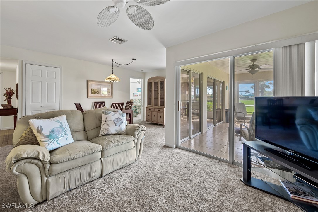 14995 Rivers Edge Court, Unit 151 Fort Myers, FL 33908 - Photo 5 of 18 a living room with furniture a flat screen tv and a window