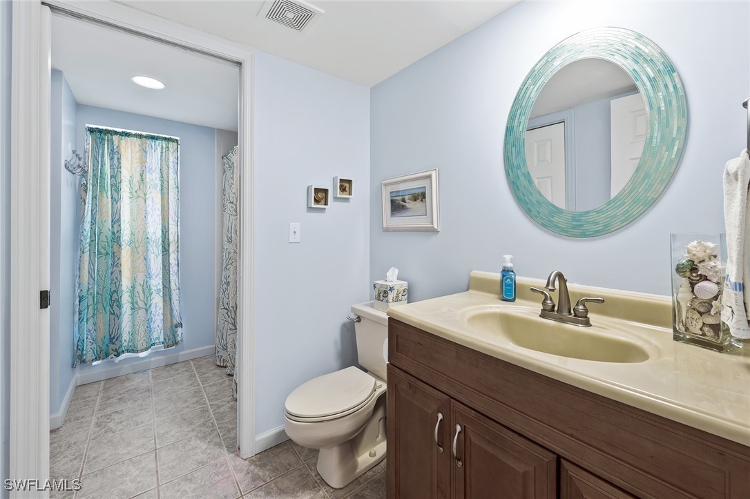 14995 Rivers Edge Court, Unit 151 Fort Myers, FL 33908 - Photo 10 of 18 a bathroom with a toilet a sink and a mirror