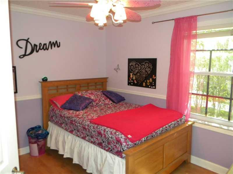 Undisclosed Address Weston, FL 33331 - Photo 14 of 23 a bedroom with a bed and a window