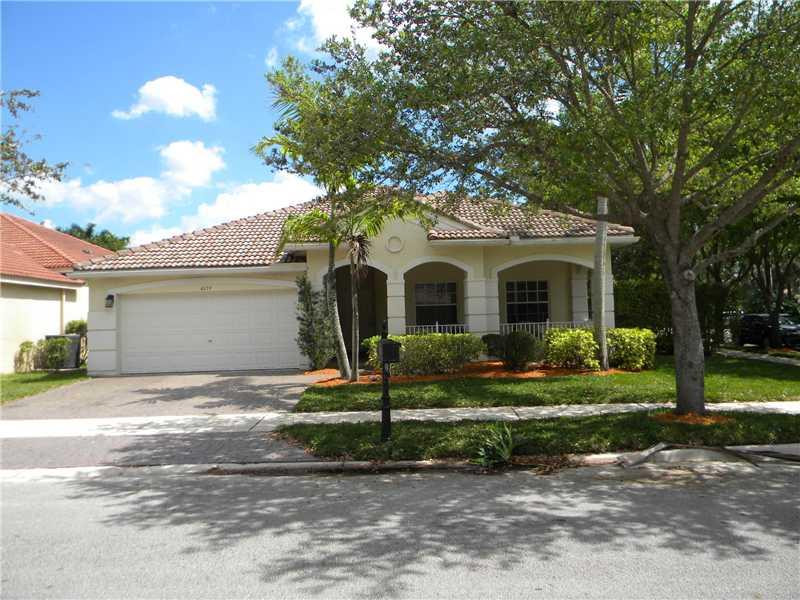 Undisclosed Address Weston, FL 33331 - Photo 2 of 23 a view of a white house with a yard and plants
