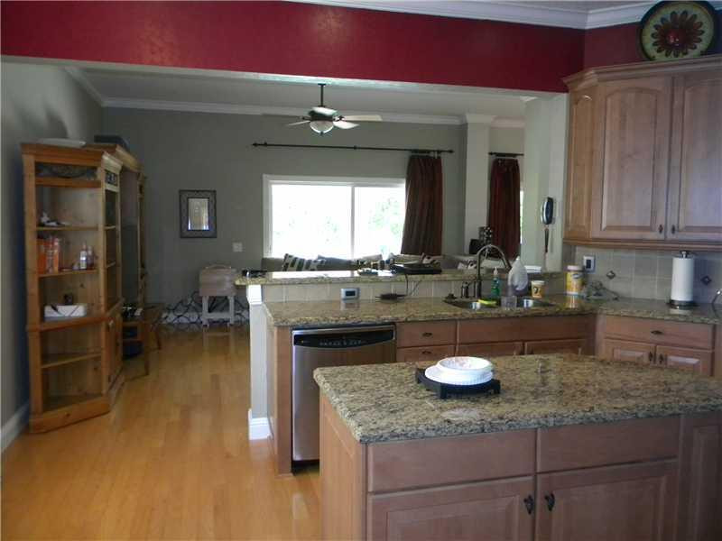 Undisclosed Address Weston, FL 33331 - Photo 8 of 23 a kitchen with a sink cabinets and wooden floor