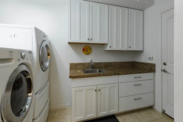 a utility room with sink dryer and washer