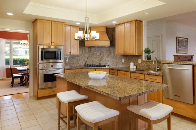 a kitchen with a table chairs sink and cabinets