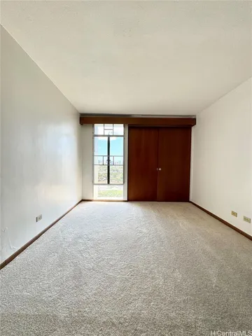 an empty room with windows and closet