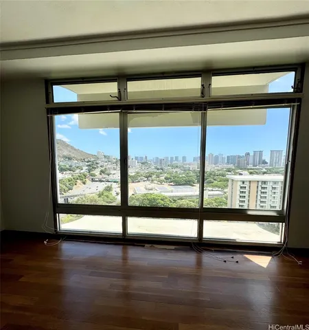 a view of a room with window and wooden floor