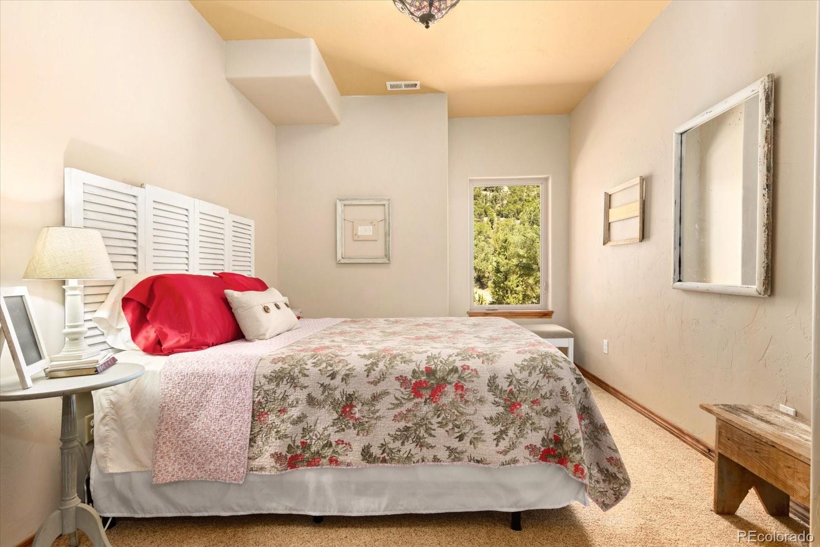 990 Hamilton Creek Road Coaldale, CO 81222 - Photo 24 of 49 a bedroom with a bed and wooden floor