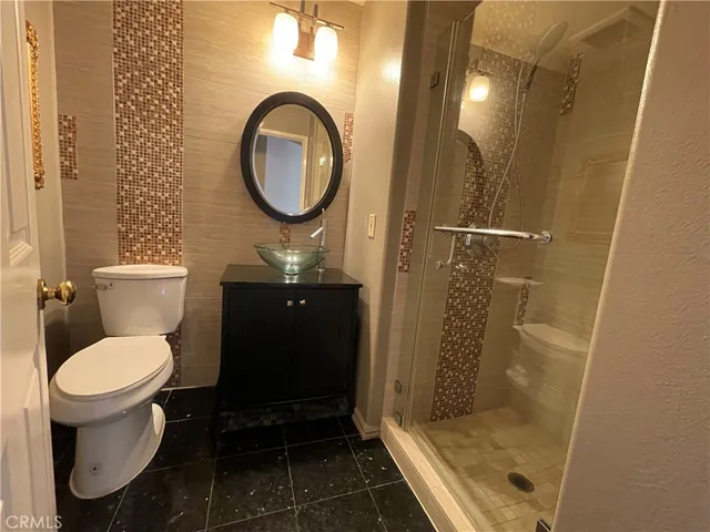 a bathroom with a toilet and a shower