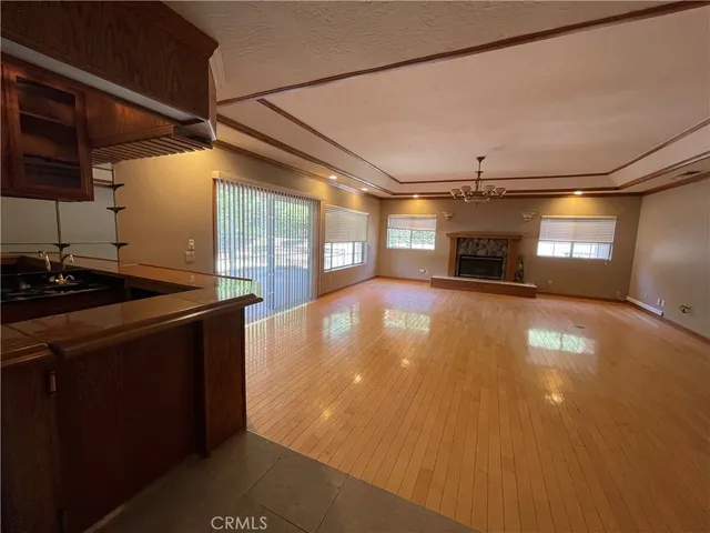 a kitchen with stainless steel appliances granite countertop a stove and a fireplace