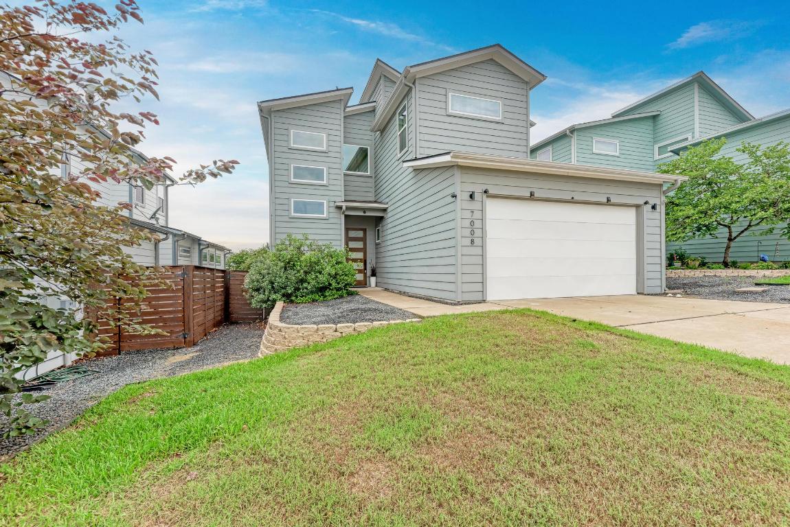 a view of a house with a yard and garage