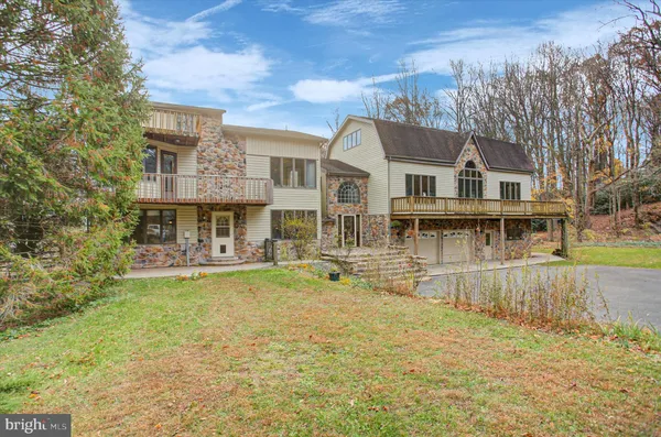 a front view of a house with swimming pool having outdoor seating