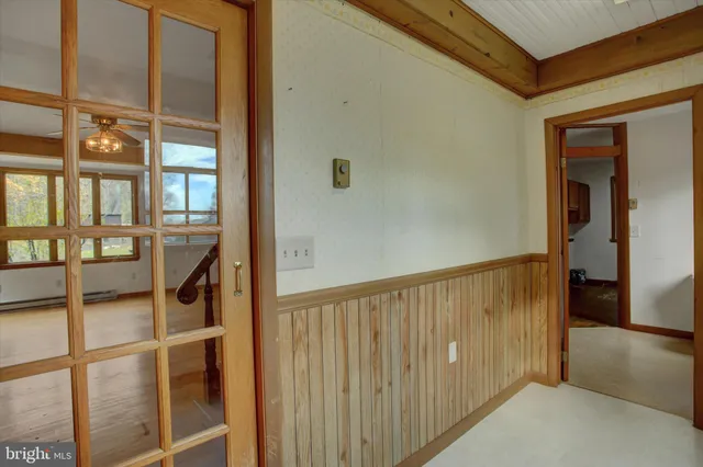 a view of a hallway with wooden floor and entryway