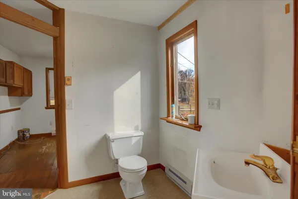 a bath tub sitting in a bathroom next to a window