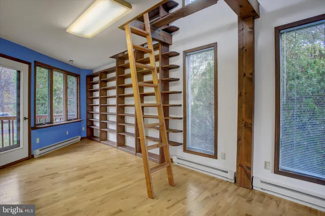 a balcony with wooden floor and trees