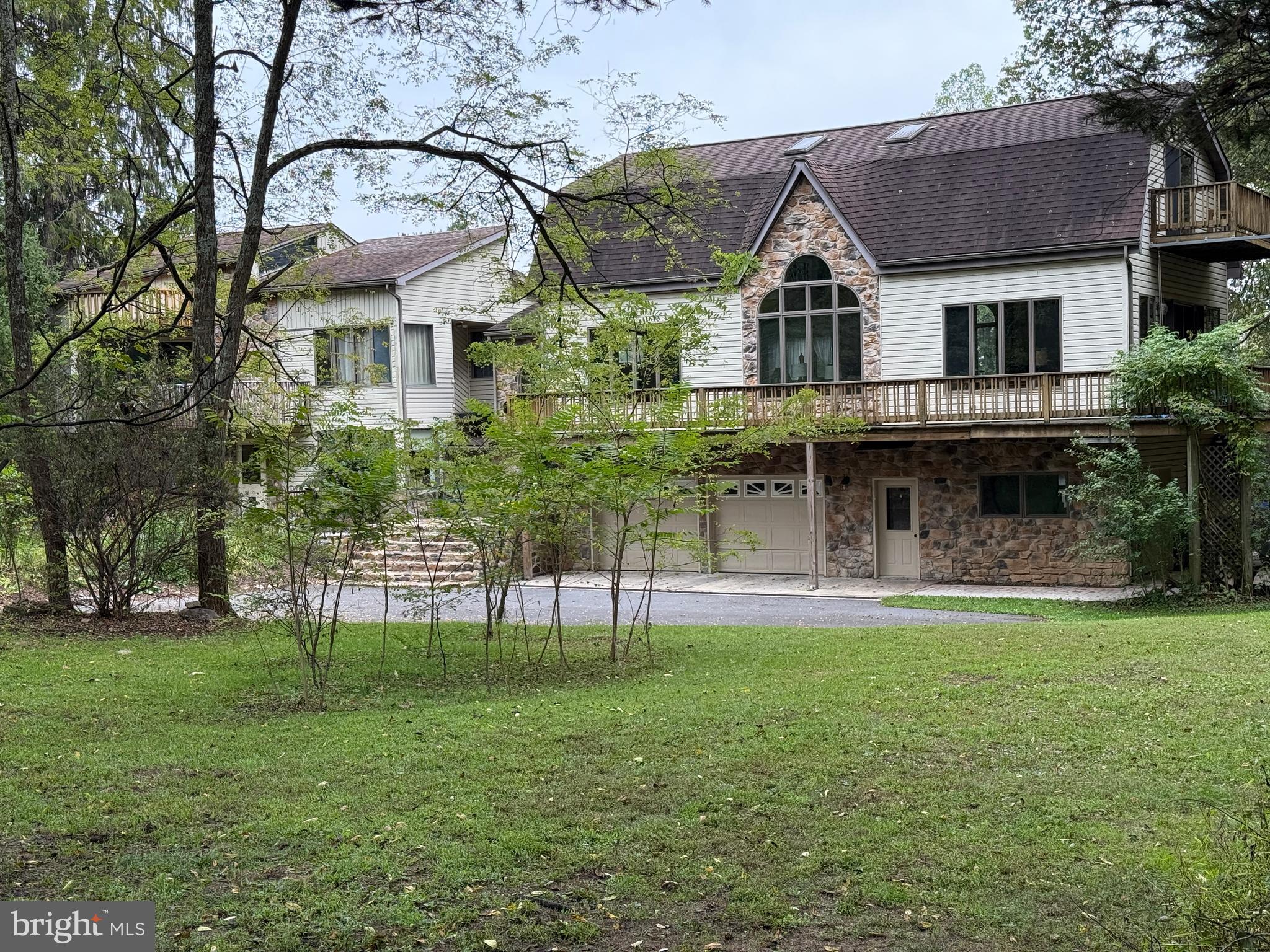 9969 Circle Drive St. Thomas, PA 17252 - Photo 9 of 81 a front view of a house with a garden
