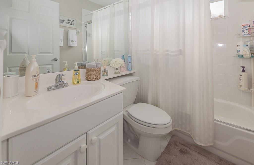 960 Partridge Circle, Unit 1202 Naples, FL 34104 - Photo 11 of 23 a bathroom with a sink a toilet and shower