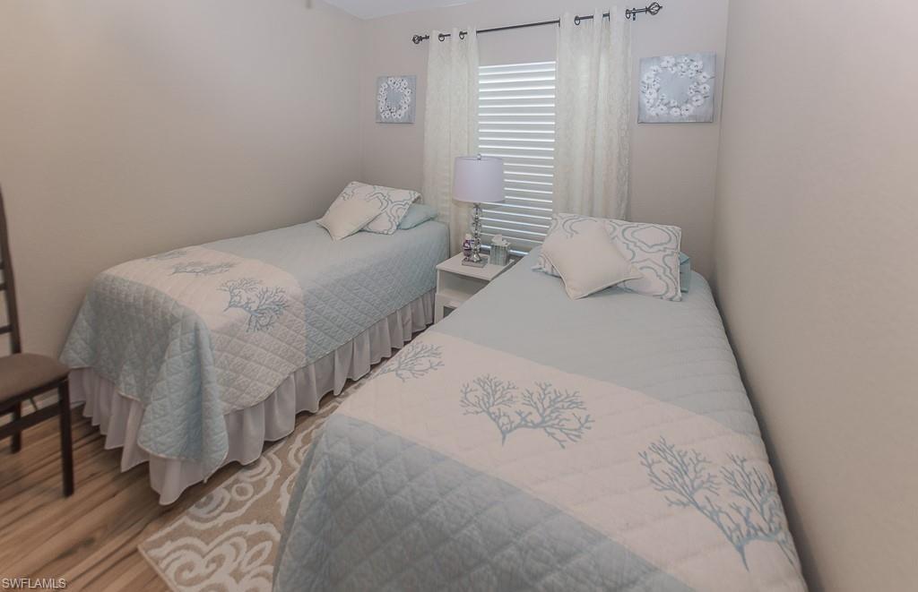 960 Partridge Circle, Unit 1202 Naples, FL 34104 - Photo 12 of 23 a bedroom with a bed and a window