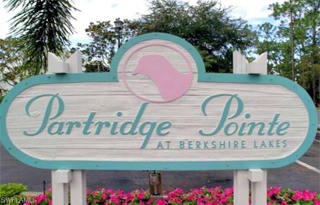 960 Partridge Circle, Unit 1202 Naples, FL 34104 - Photo 18 of 23 a sign that is on a brick wall