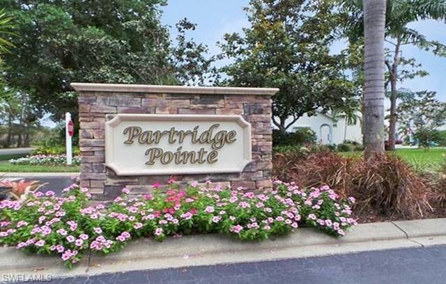 960 Partridge Circle, Unit 1202 Naples, FL 34104 - Photo 20 of 23 a sign on the side of a building