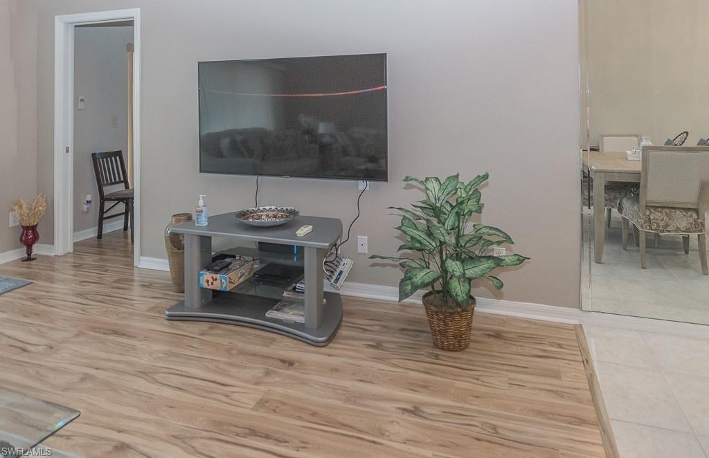 960 Partridge Circle, Unit 1202 Naples, FL 34104 - Photo 2 of 23 a living room with furniture and a potted plant