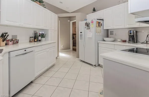 a kitchen with a refrigerator and cabinets
