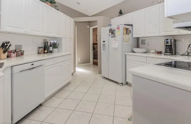 a kitchen with a refrigerator and cabinets