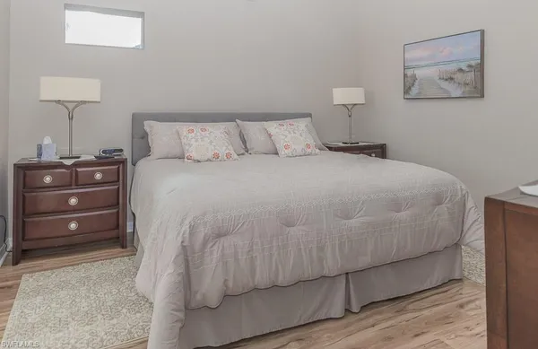 a bedroom with a bed and a lamp