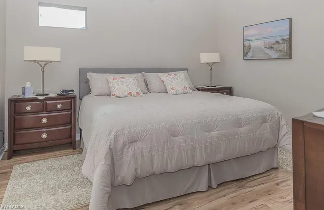 a bedroom with a bed and a lamp