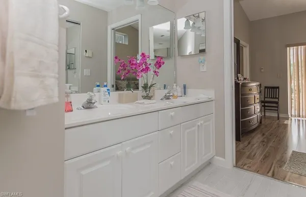 a bathroom with a sink vanity and a mirror