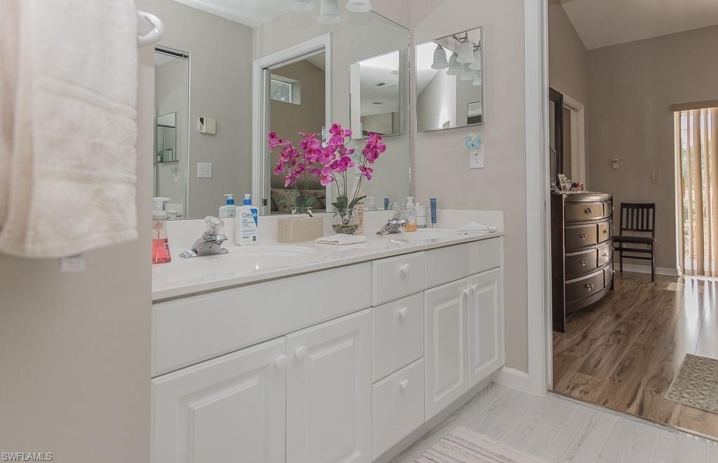 960 Partridge Circle, Unit 1202 Naples, FL 34104 - Photo 7 of 23 a bathroom with a sink vanity and a mirror