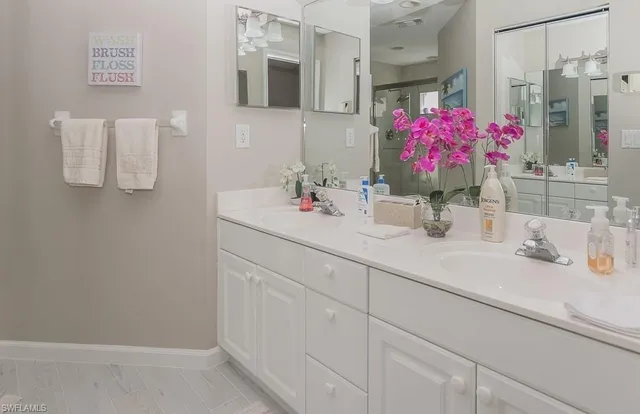 a bathroom with a sink vanity and mirror