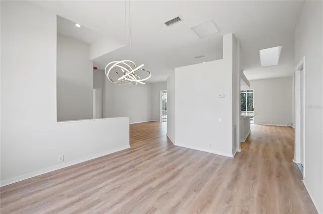 a view of a room with wooden floor