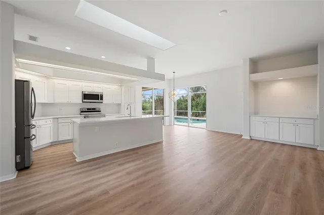 a view of a kitchen with wooden floor