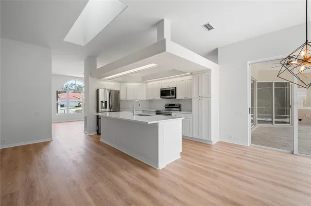 a kitchen with stainless steel appliances kitchen island wooden cabinets and granite counter tops
