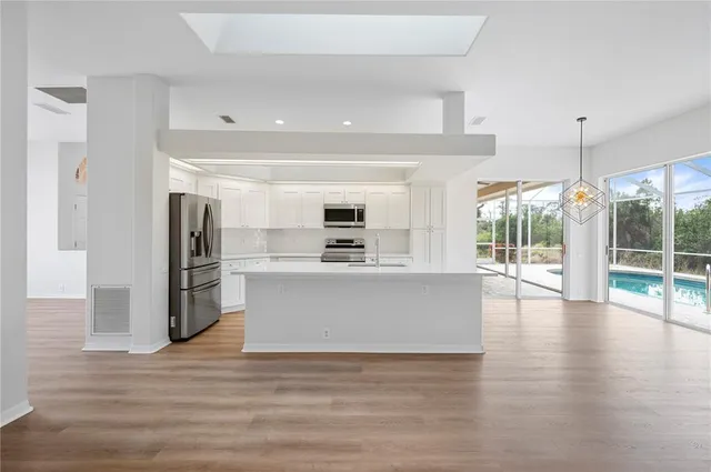 a view of kitchen with cabinets and stainless steel appliances